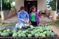 Two women in the village selling fresh watermelon