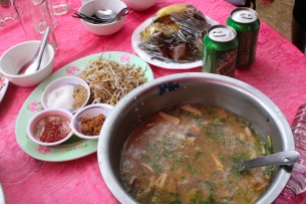 A traditional Cambodian meal served at the memorial service: seafood and pork stew with sugar, sprouts, beans, and chilis as fixings, and bananas and rice cakes for dessert.